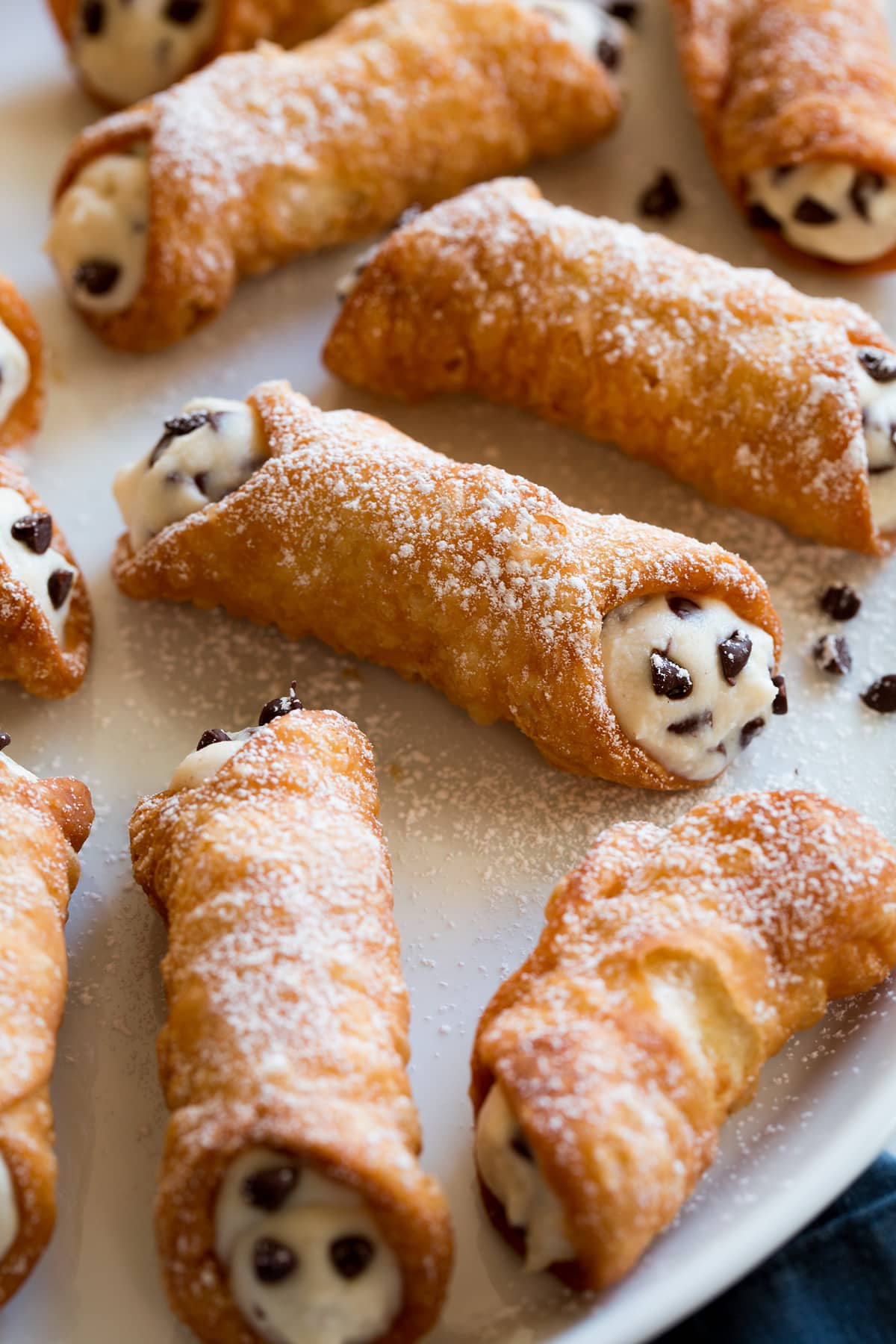 Cannoli on a serving platter, showing one close up.