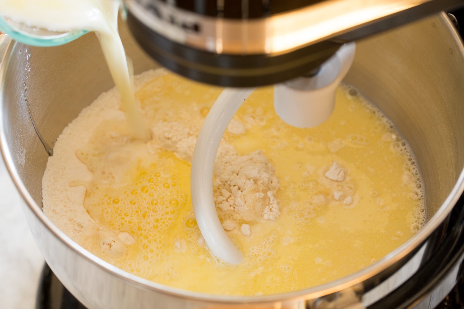 Dry and wet ingredients being mixed for dough.