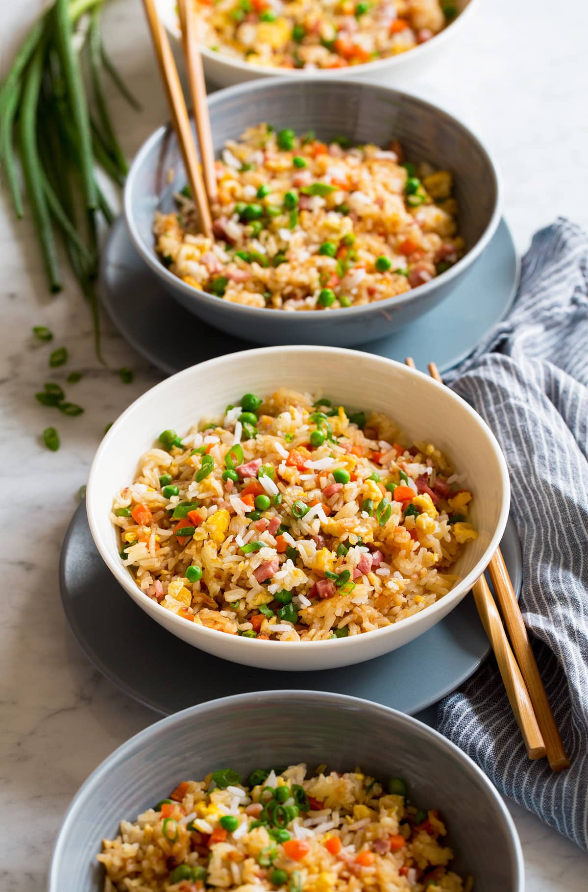 Fried rice shown in four bowls in a row.