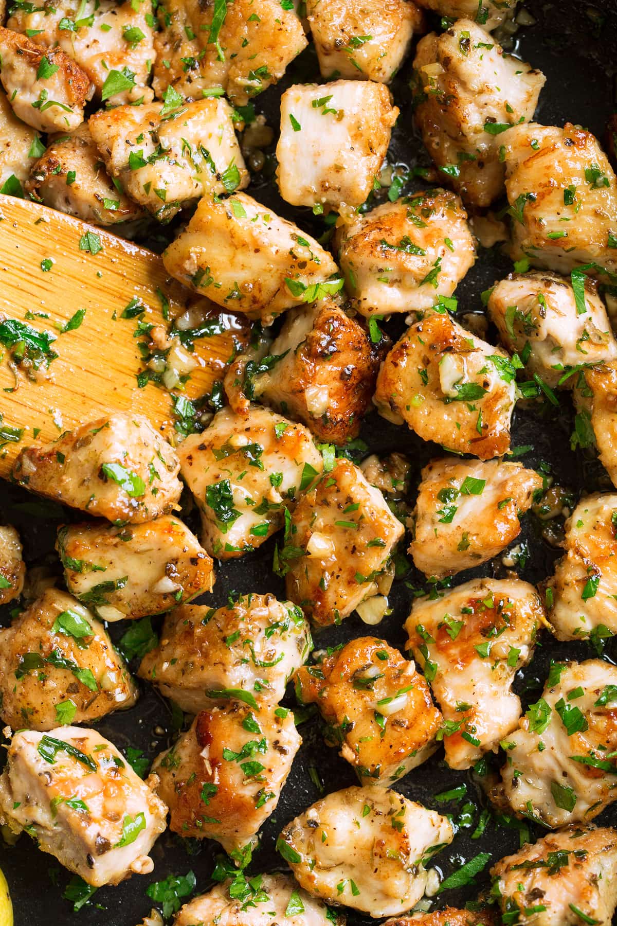 Close up image of garlic butter chicken bites in a skillet.