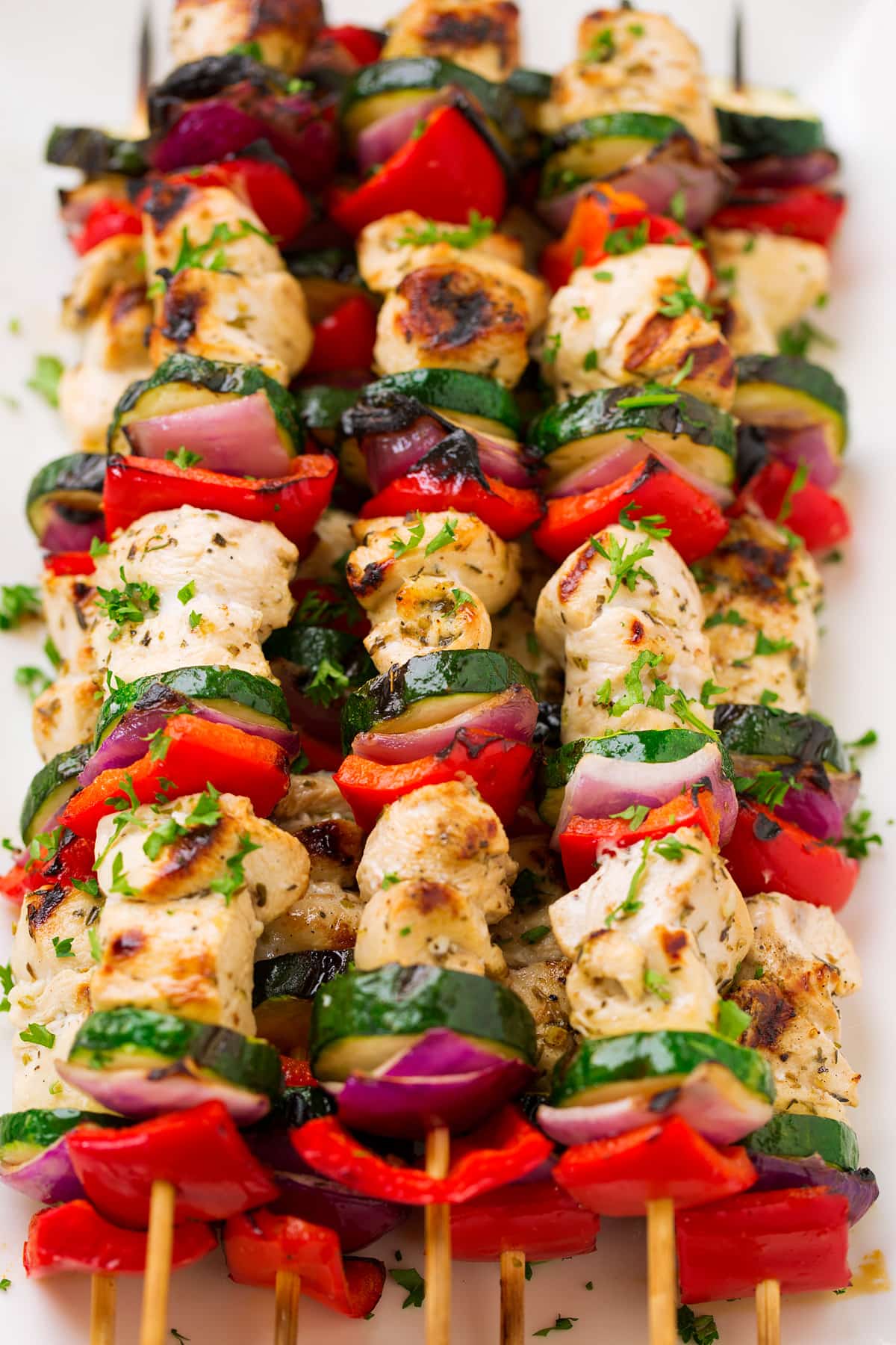 Greek Chicken Kebabs on skewers with marinated chicken breast, zucchini, bell pepper and red onion.