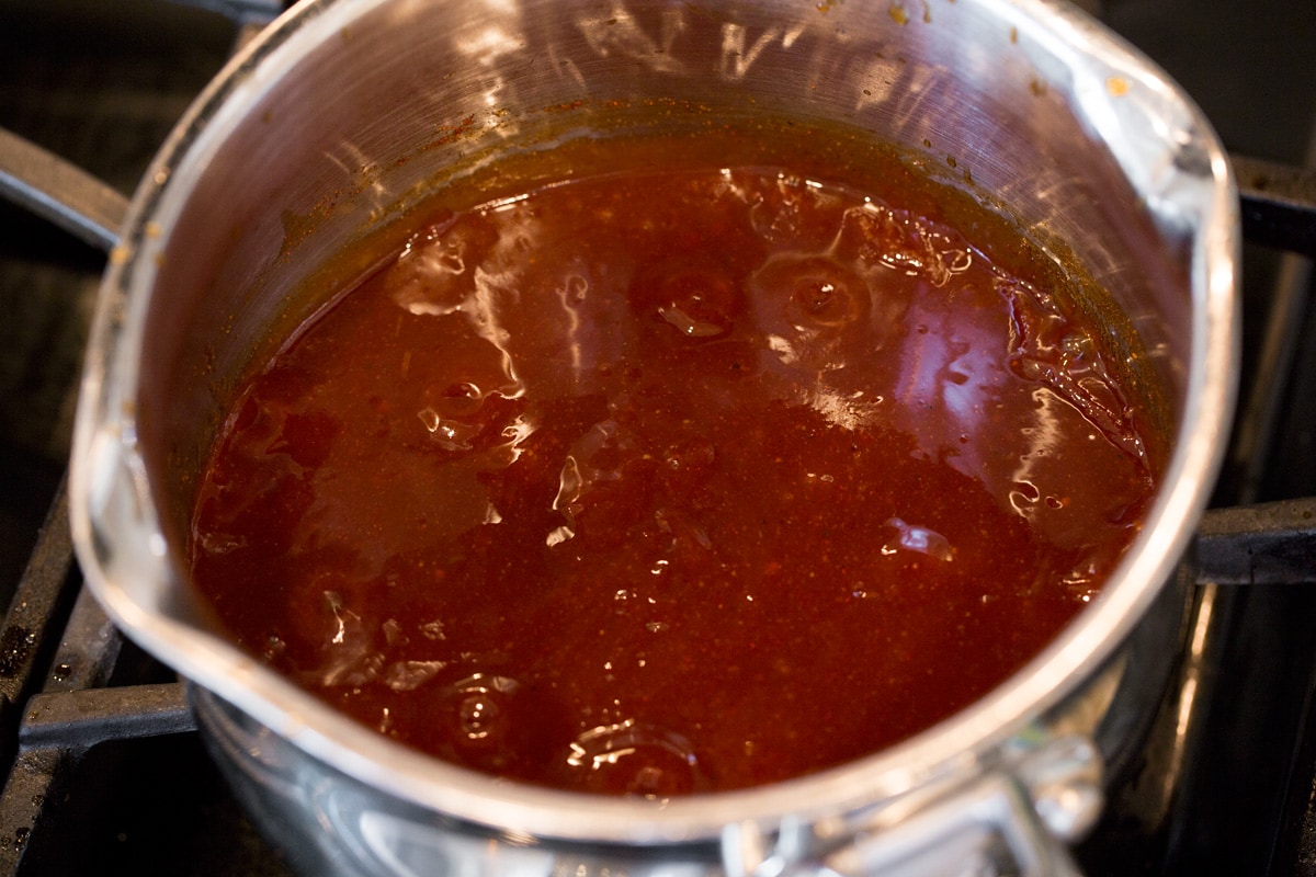 BBQ sauce simmering on stovetop.
