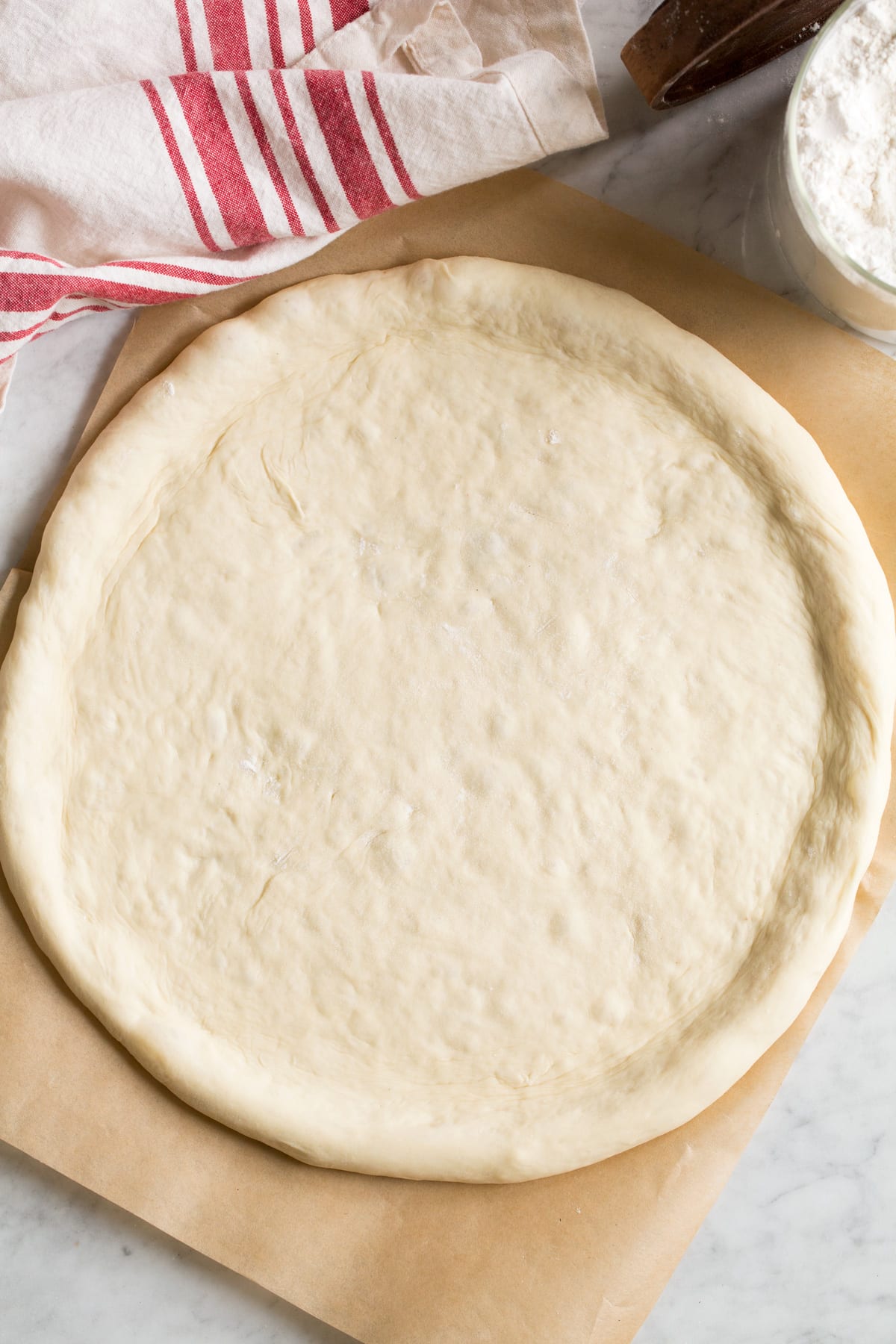 Overhead image of shaped pizza crust without toppings.