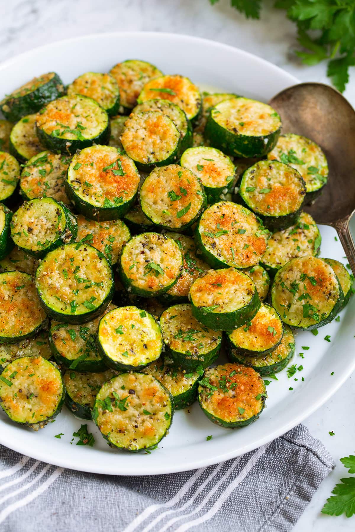 Baked zucchini shown in slices, from a side angle.