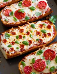 French Bread Pizza shown from a side angle on a baking sheet.