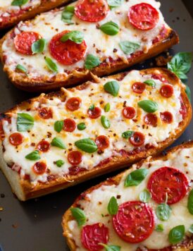 French Bread Pizza shown from a side angle on a baking sheet.