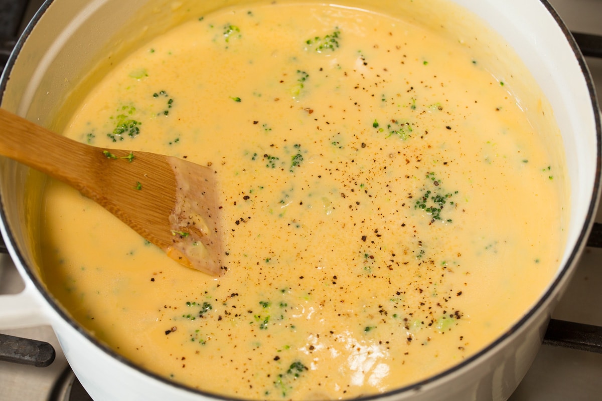 Pot of finished broccoli cheese soup shown on the stove top.