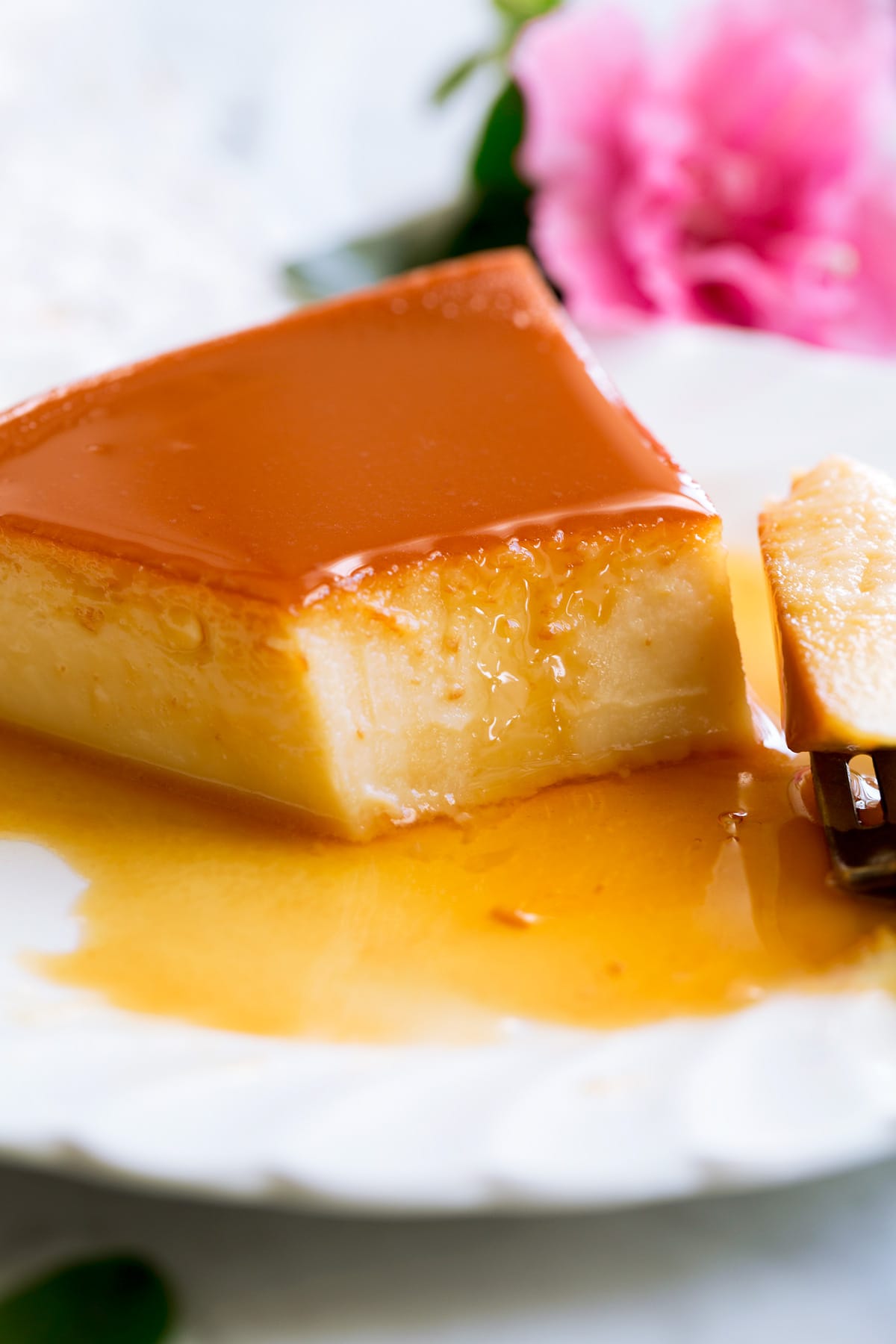 Close up image of flan cut into with a fork.