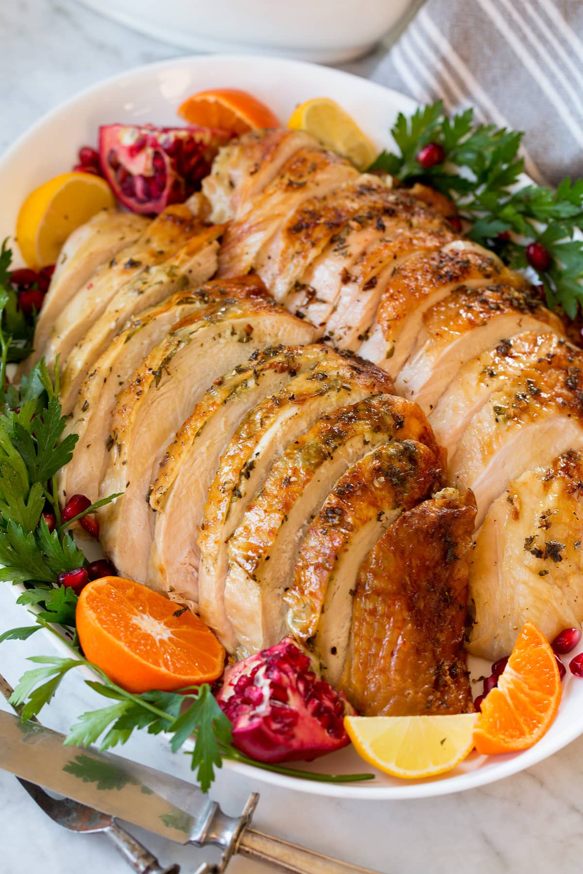 Roast Turkey Breast sliced on a serving platter with sides of fruit.