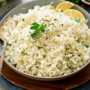 Photo of cauliflower rice shown from the side in a serving bowl.
