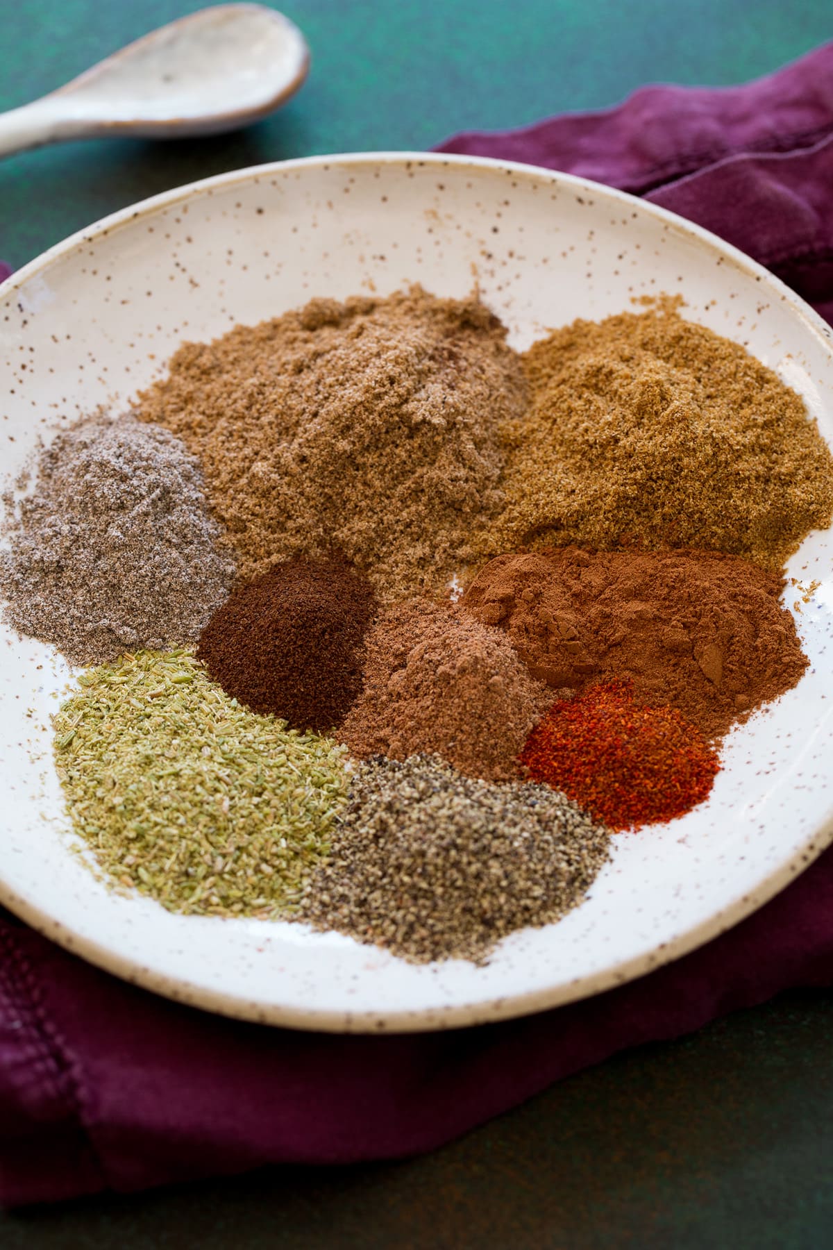 Garam masala pre-ground spices in a bowl before mixing.