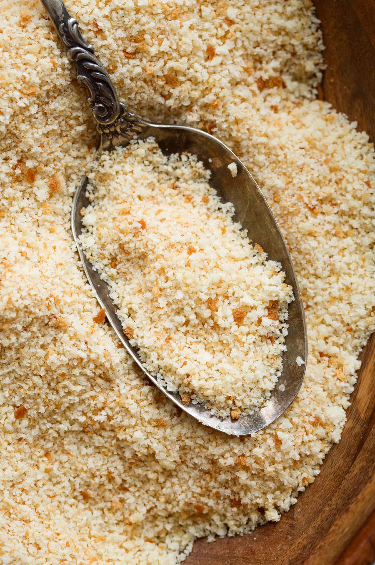 Close up photo of bread crumbs on a spoon.