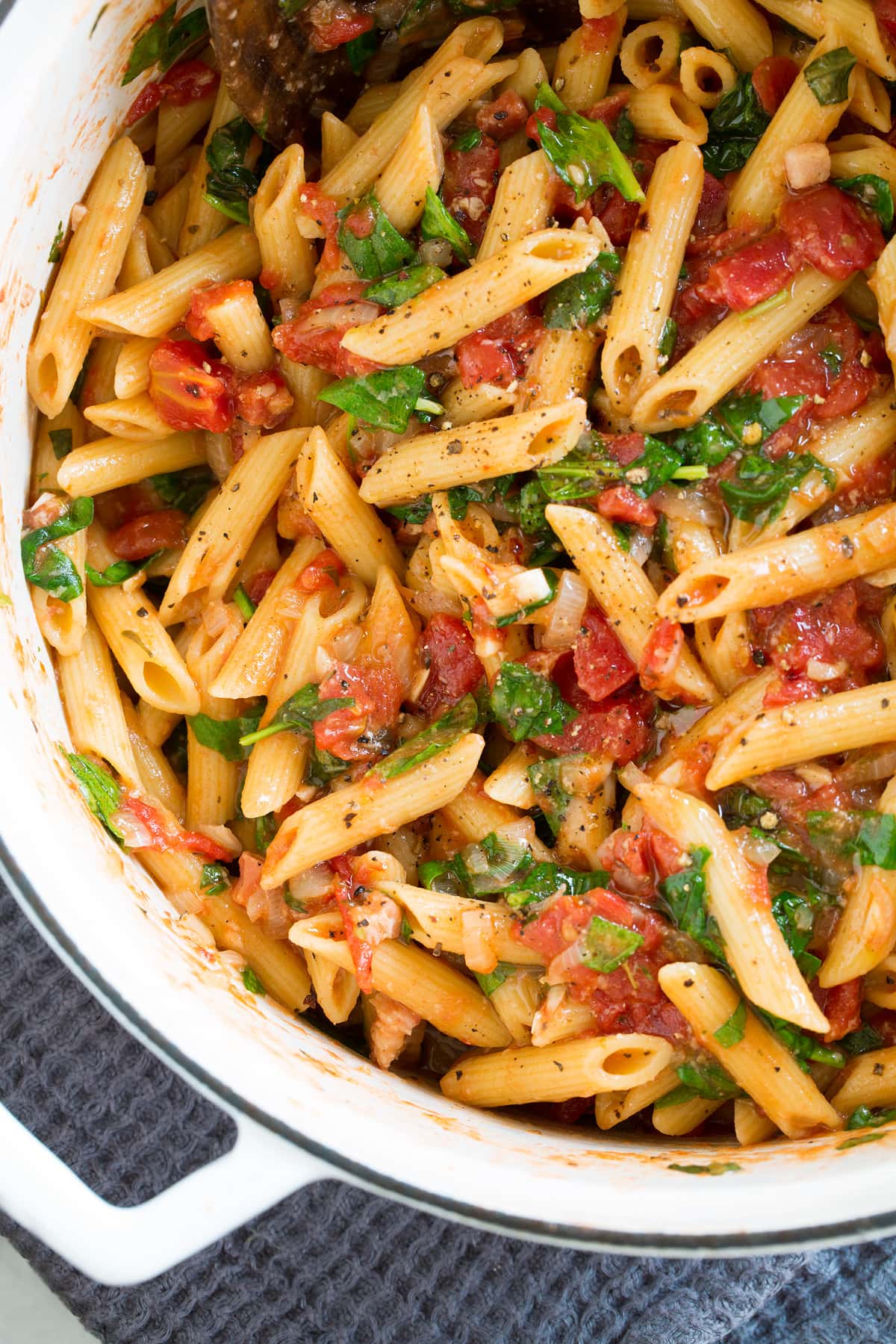 Close up photo of one pot pasta in a large white pot.