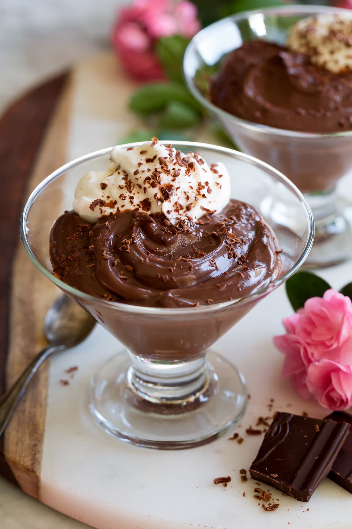 Photo: Single serving of chocolate pudding in a pretty glass cup with dark chocolate pieces shown to the side.