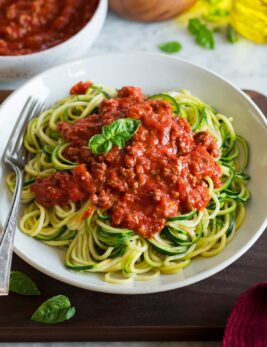 Zucchini Noodles shown topped with a beefy spaghetti sauce.