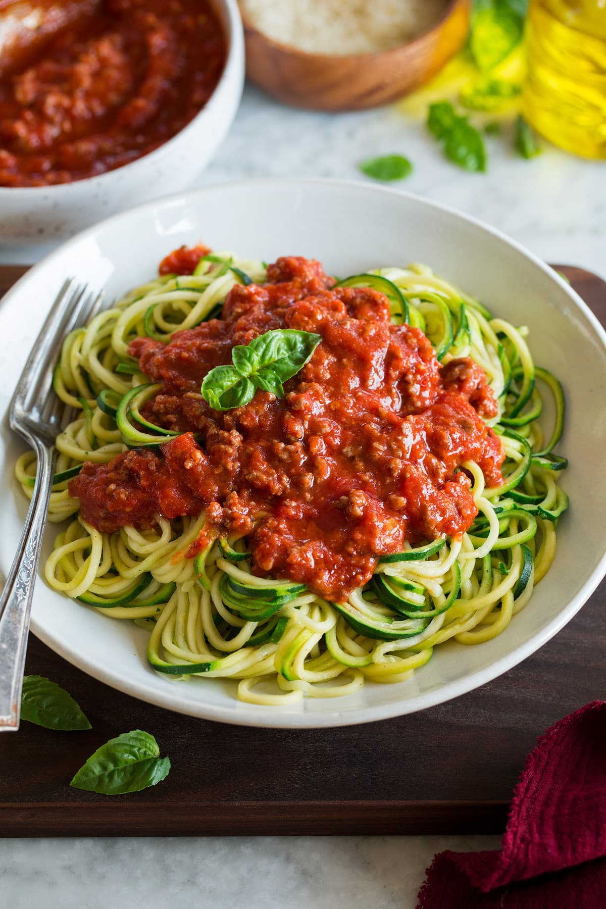 Zucchini Noodles shown topped with a beefy spaghetti sauce.