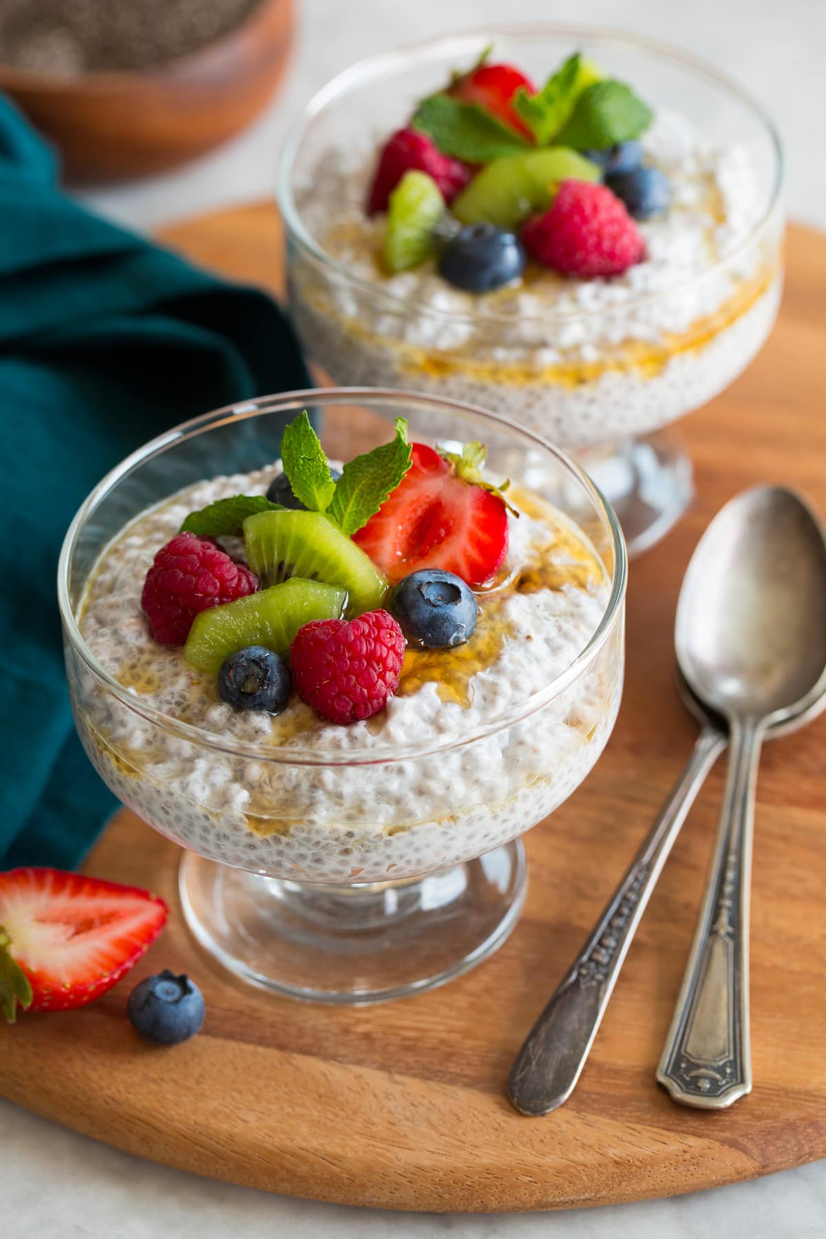 Two servings of chia seed pudding topped with diced fruit.