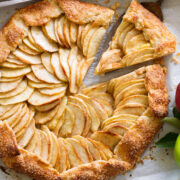Overhead photo of apple galette with a slice being removed.