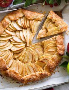 Overhead photo of apple galette with a slice being removed.