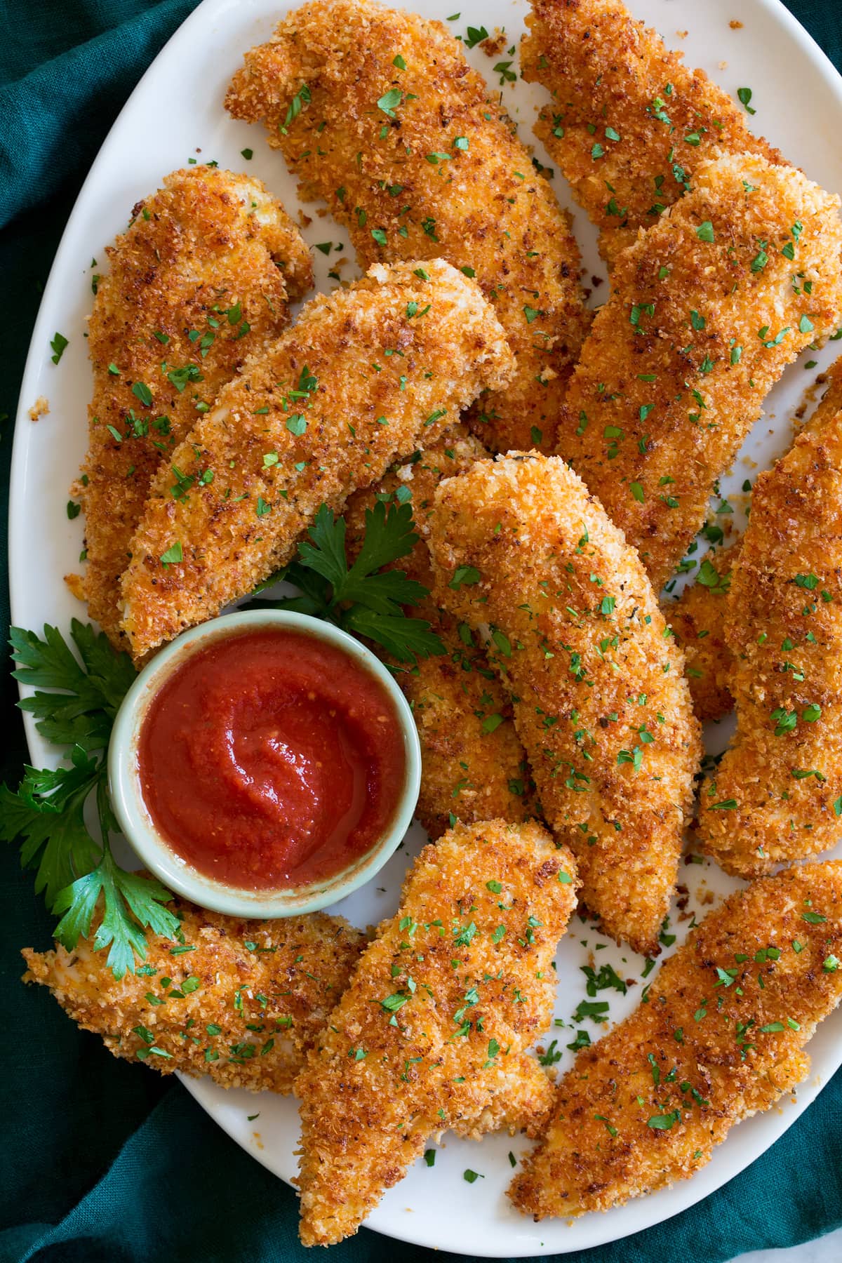 Baked chicken tenders served with marinara sauce.