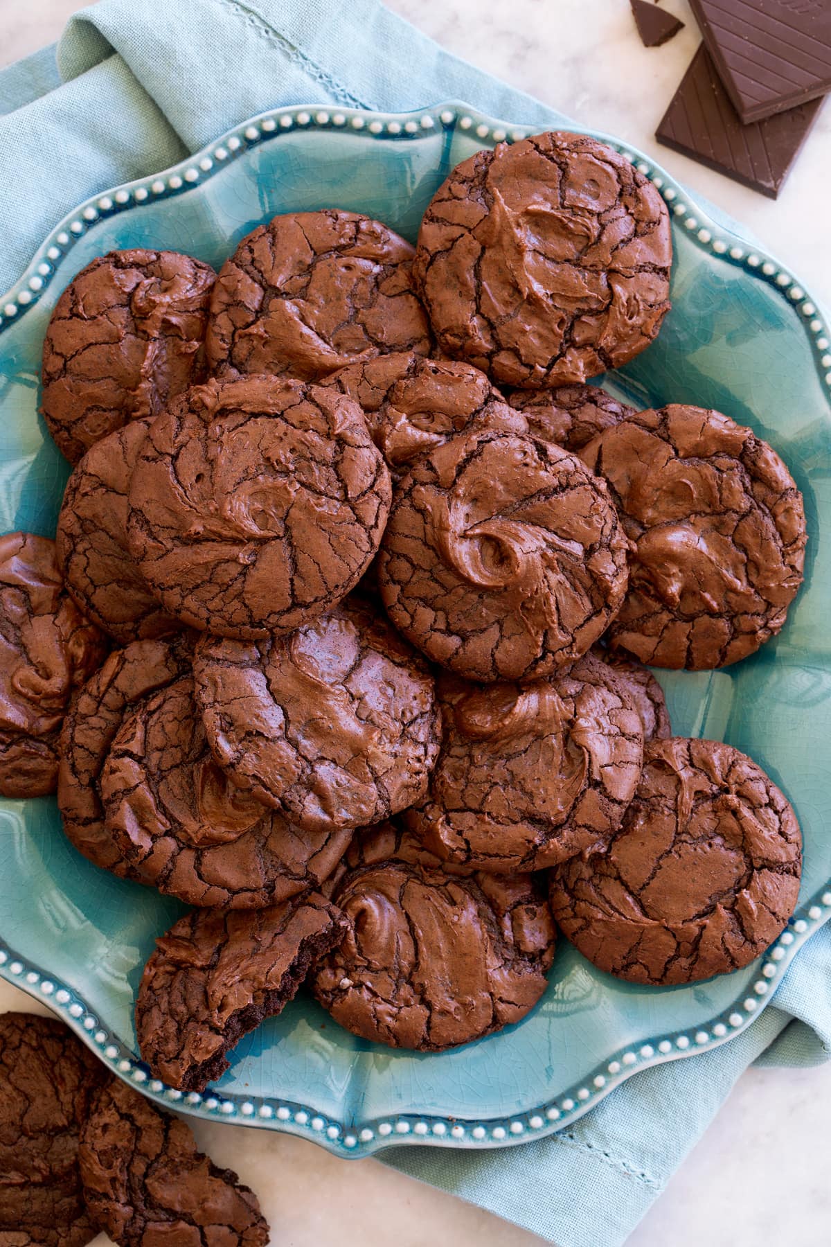 Plate full of crinkled brownie cookies on a large plate.