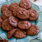 Brownie Cookies shown piled together on a turquoise serving plate.