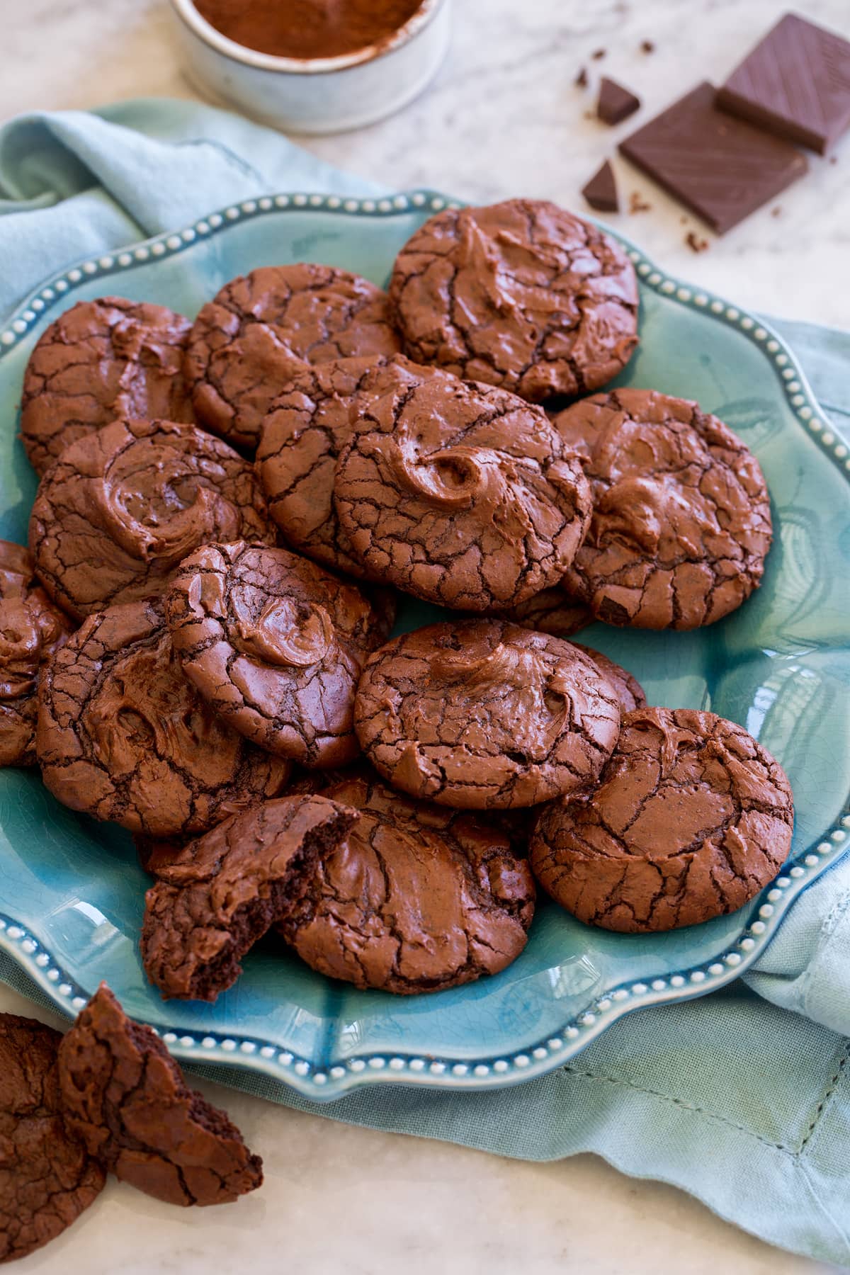 Brownie Cookies shown piled together on a turquoise serving plate.