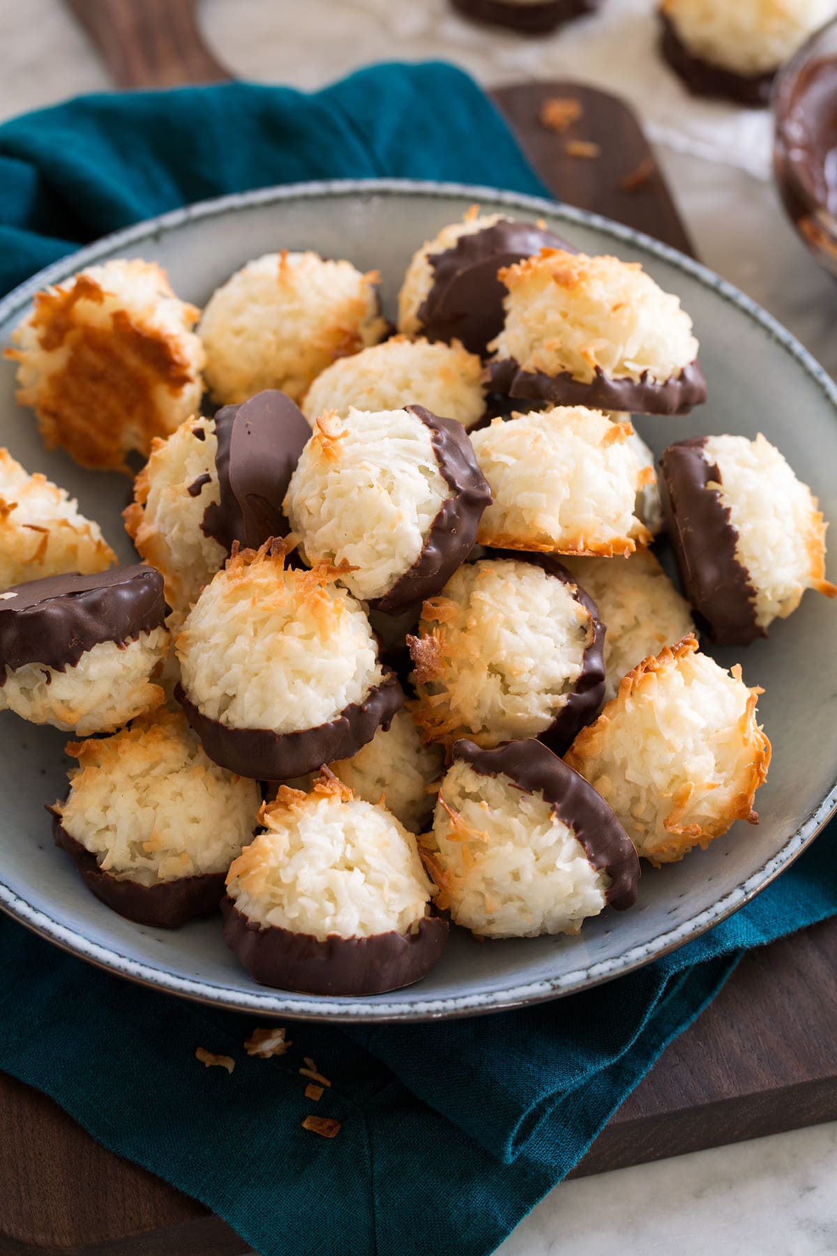 Bowl full of chocolate dipped coconut macaroons.
