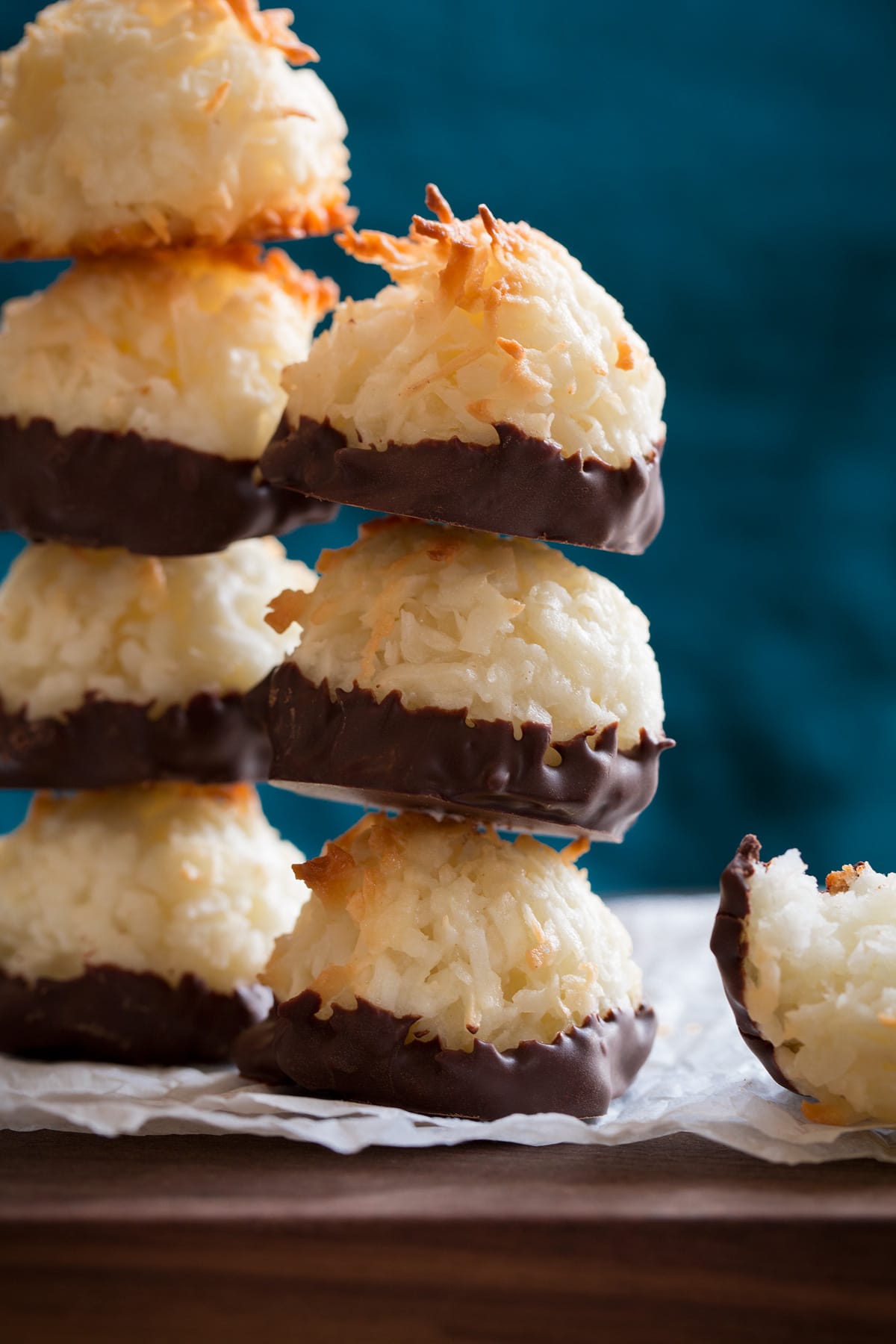 Two stacks of coconut macaroons dipped in chocolate.