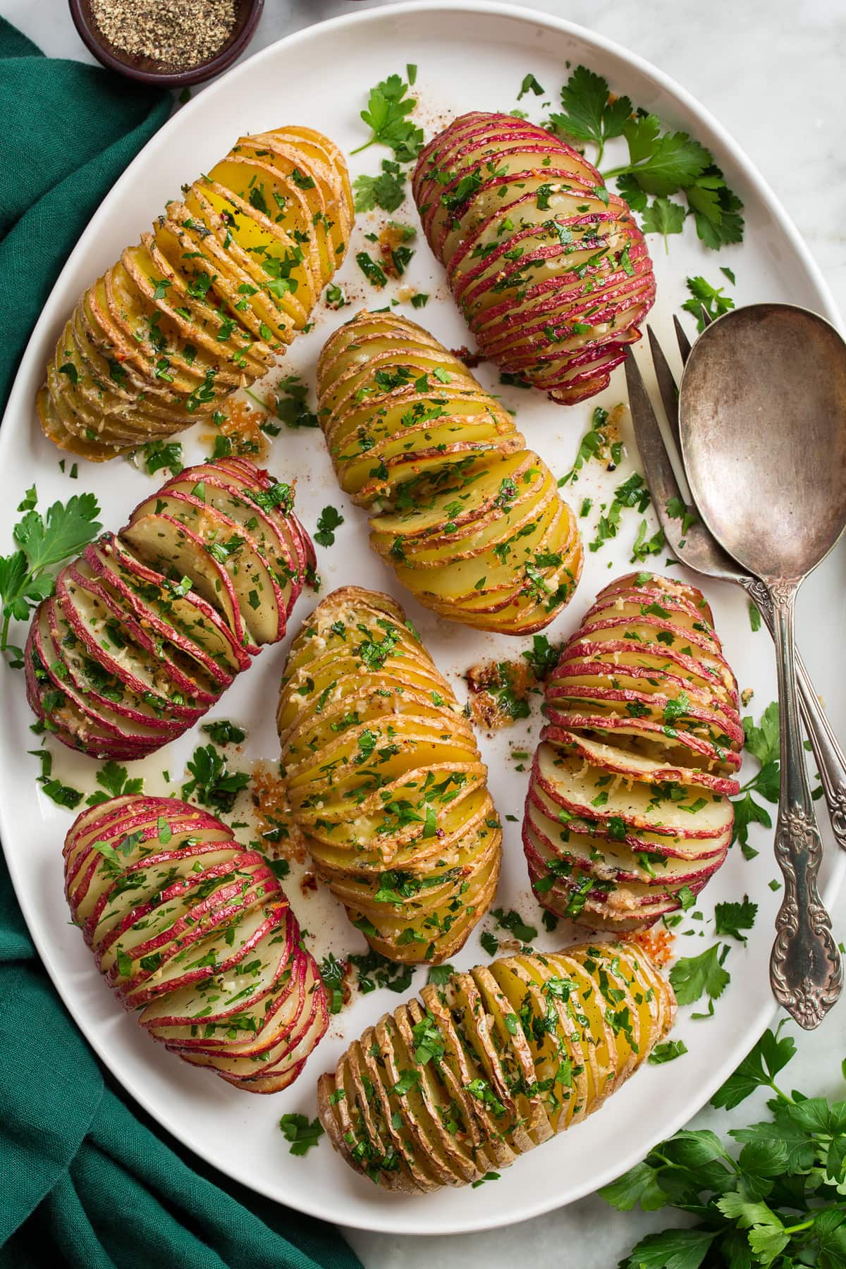 Close overhead photo of red and yukon gold hasselback potatoes.
