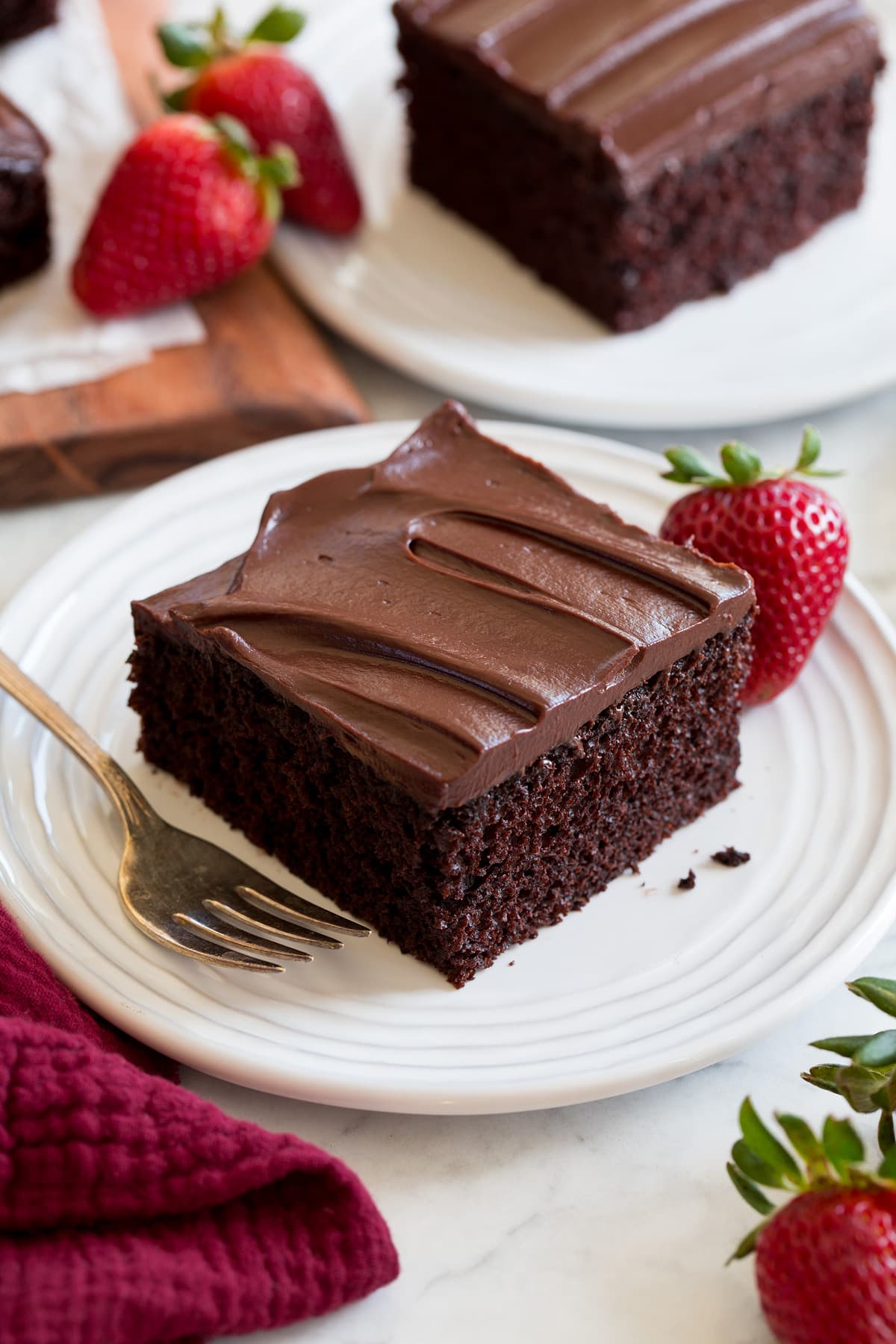 Slice of easy to make chocolate cake covered with a chocolate ganache frosting.