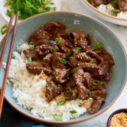 Serving of beef bulgogi paired with rice in a light blue bowl.