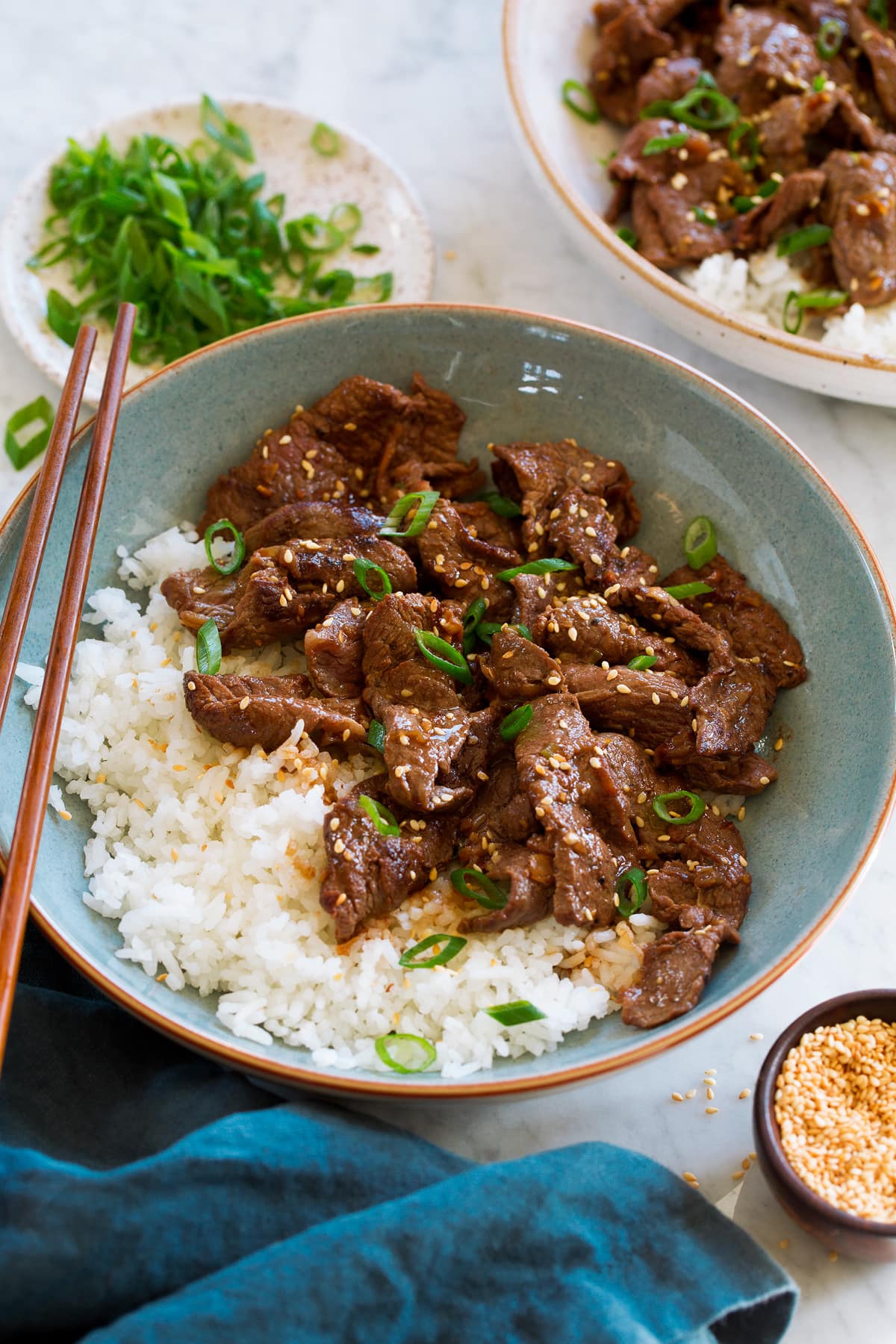Serving of beef bulgogi paired with rice in a light blue bowl.