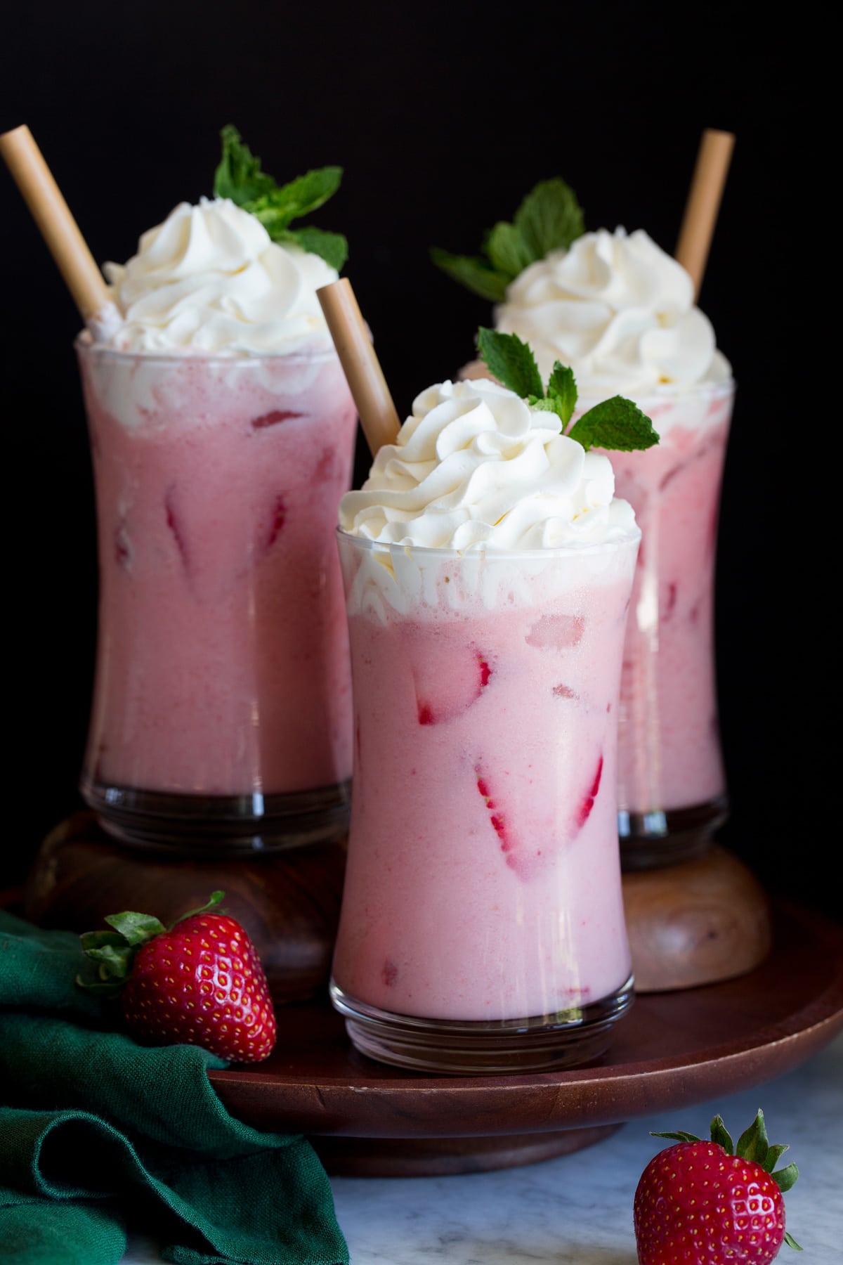 Copycat Starbucks Pink Drink recipe. Shows three servings topped with whipped cream.