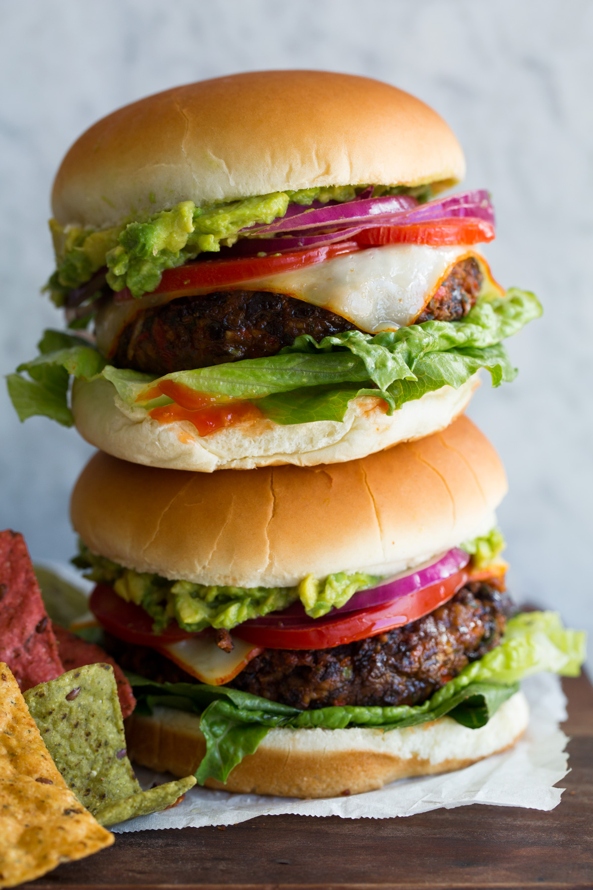 Close up photo of two black bean burgers stacked.