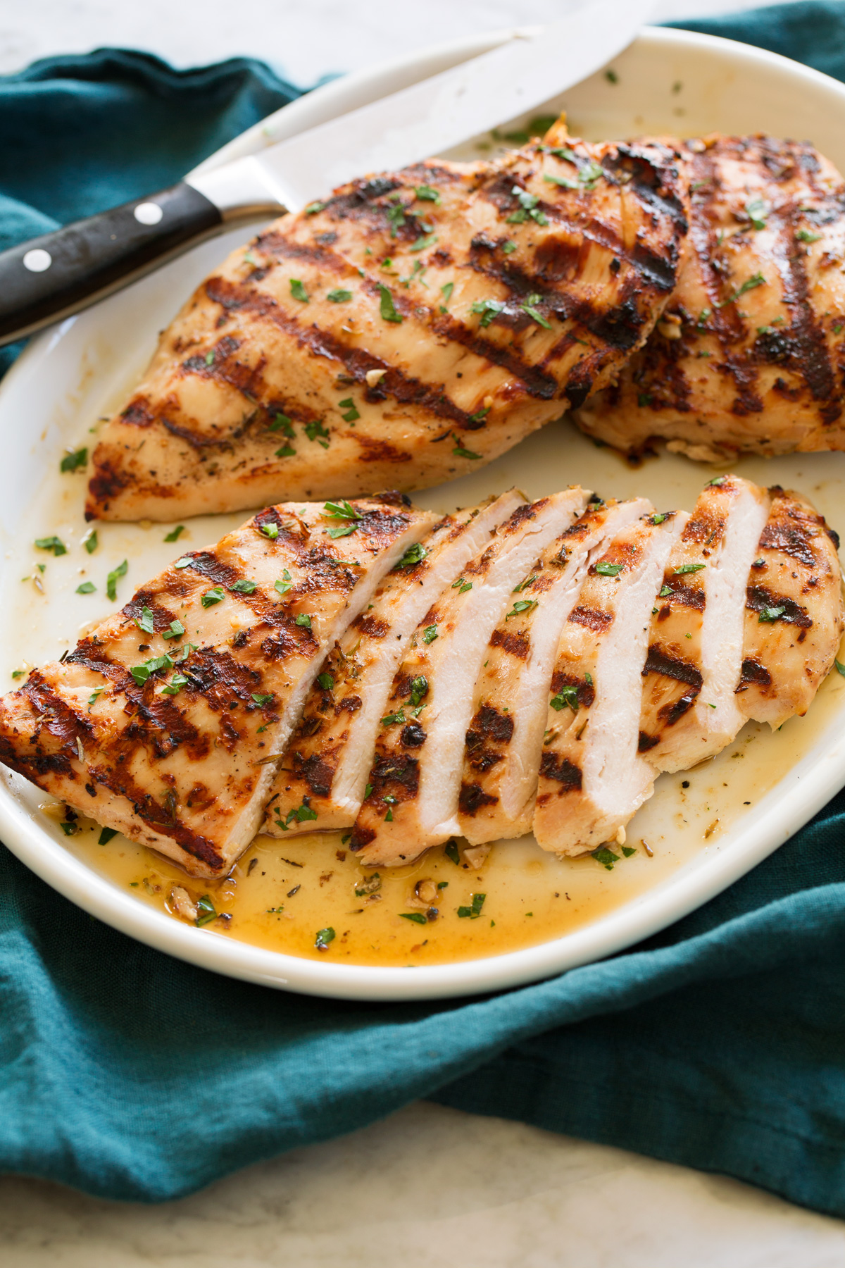 Sliced grilled chicken breasts showing juicy interior.