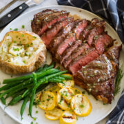 Grilled steak sliced and served with rosemary garlic butter.