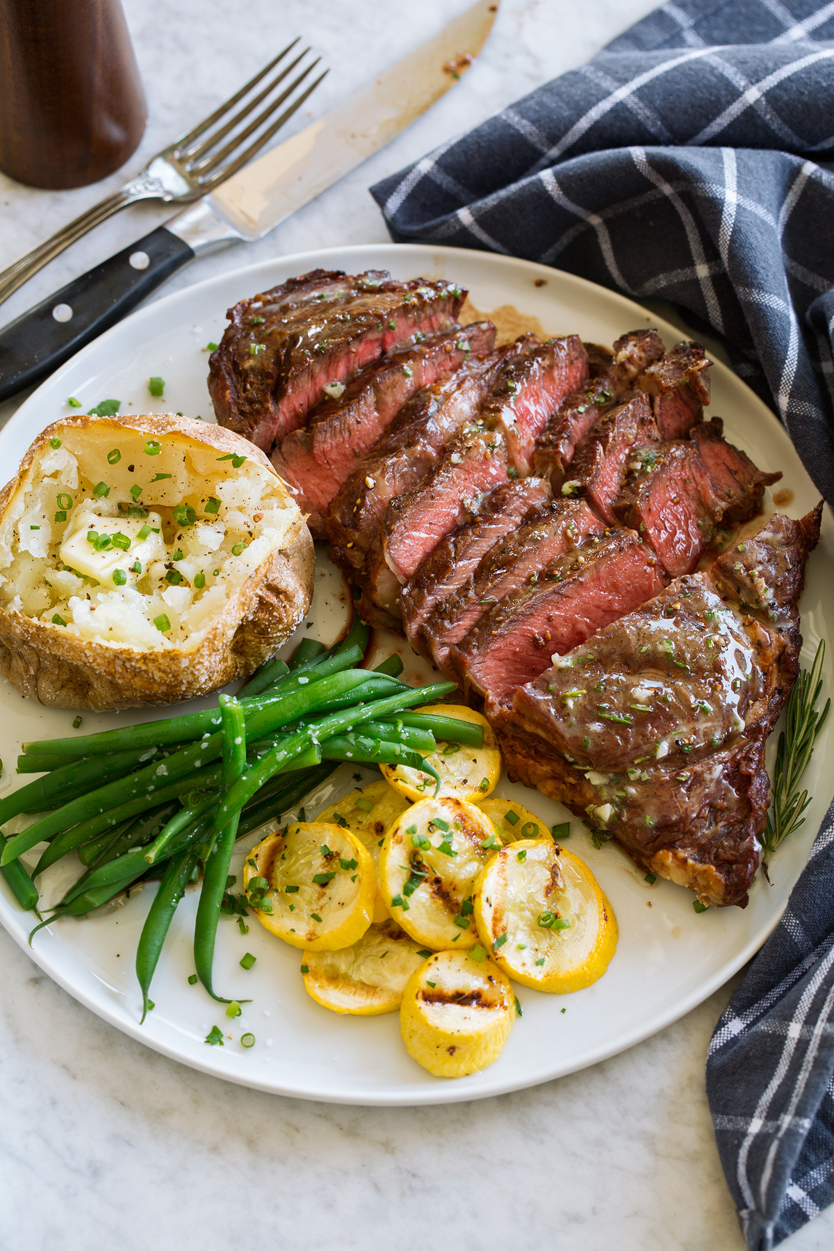 Grilled steak sliced and served with rosemary garlic butter.