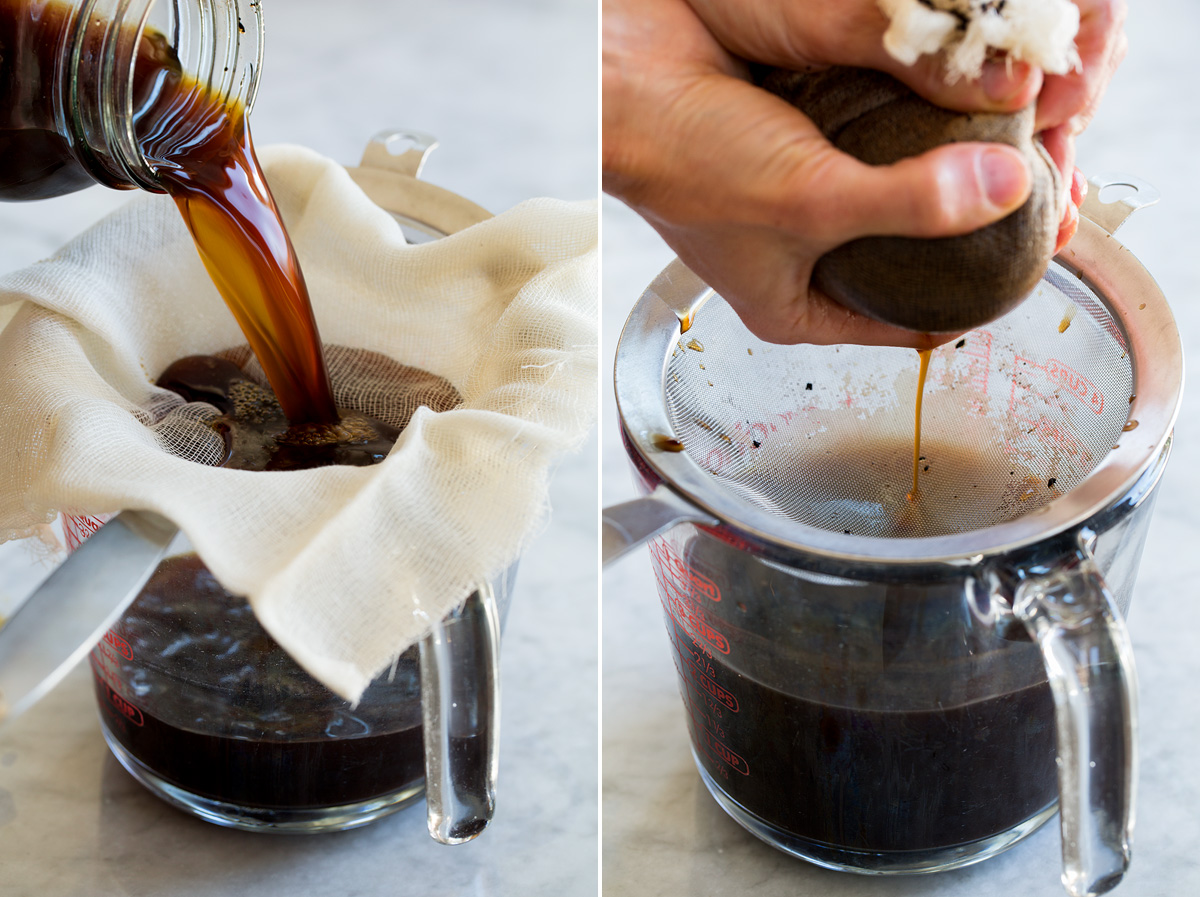 Ground coffee being strained through a cheesecloth over a sieve on a glass measuring cup.