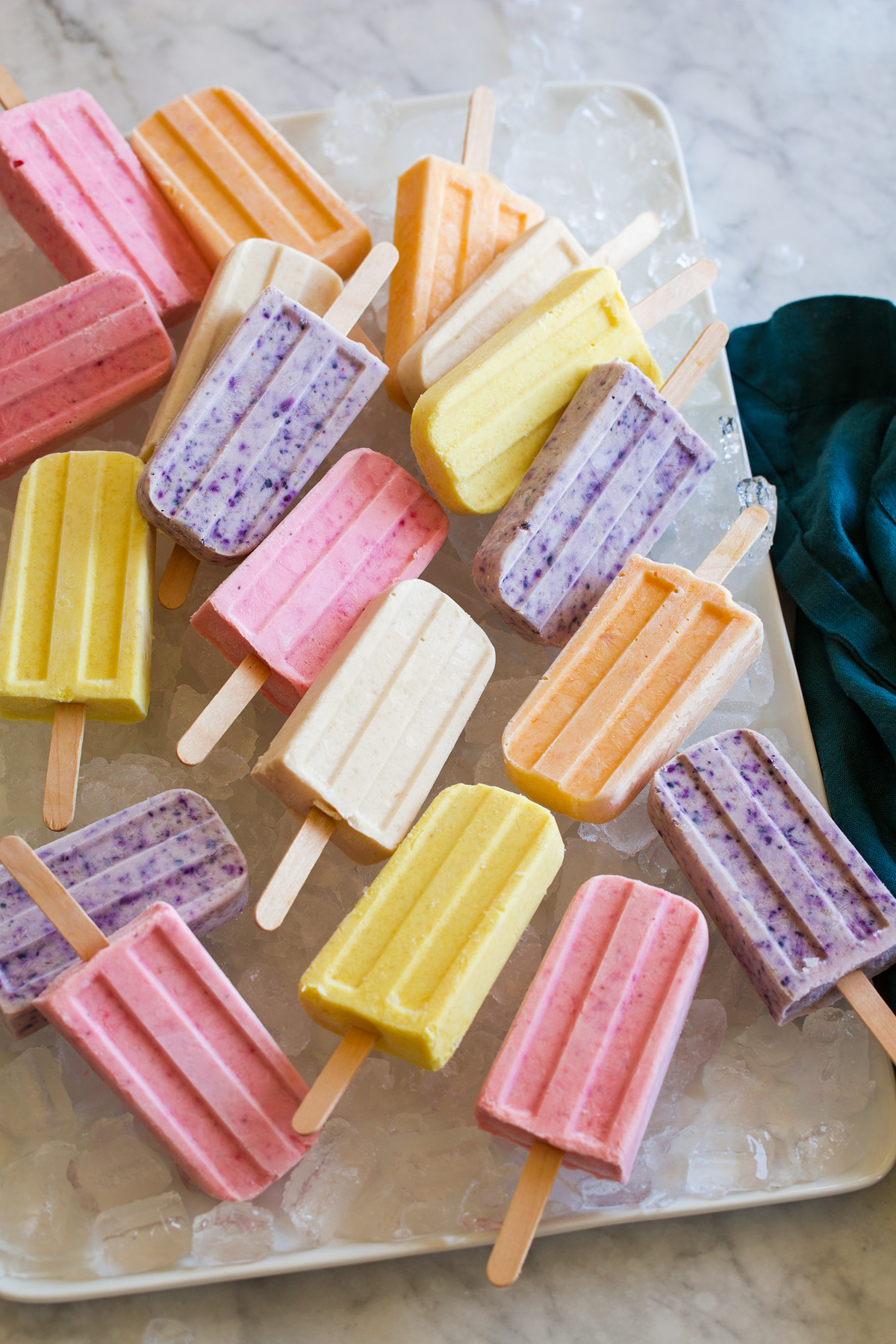 Strawberry, pineapple, banana, peach and blueberry flavored homemade popsicles.