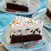 Ice cream cake with chocolate cake, fudge sauce, cookies and cream ice cream and whipped cream topping.