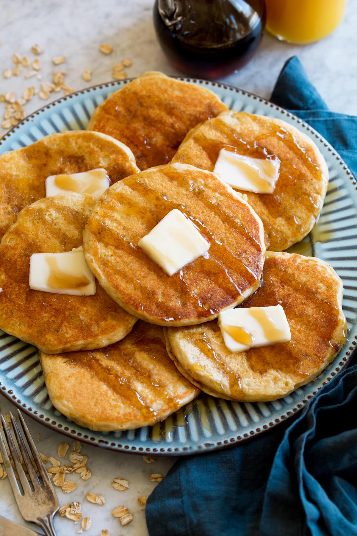 Pancakes shown at a side angle on a large blue plate.