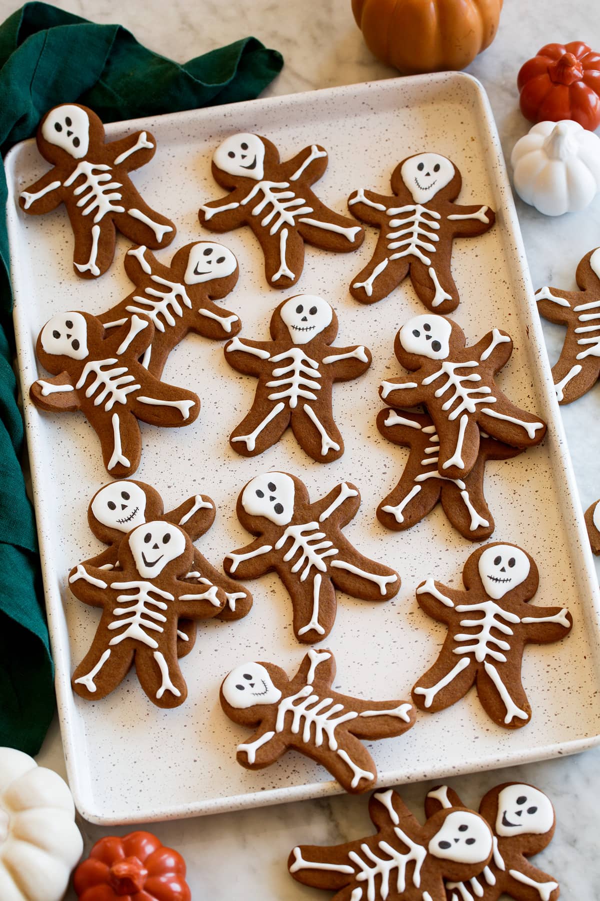 Halloween gingerbread with icing shown from the side on a baking sheet.