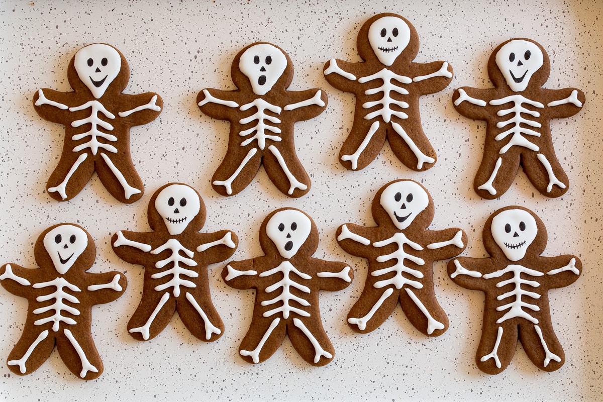Two rows of finished skeleton gingerbread cookies