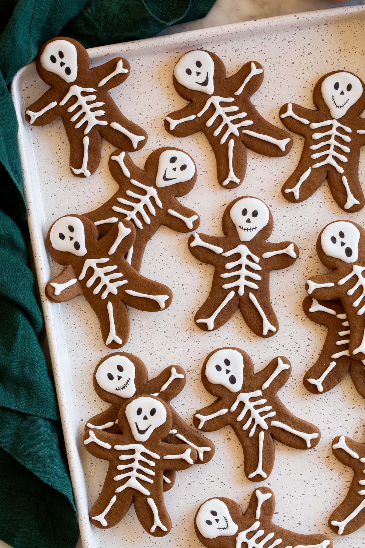 Gingerbread cookies with skeleton bodies piped over with white icing.