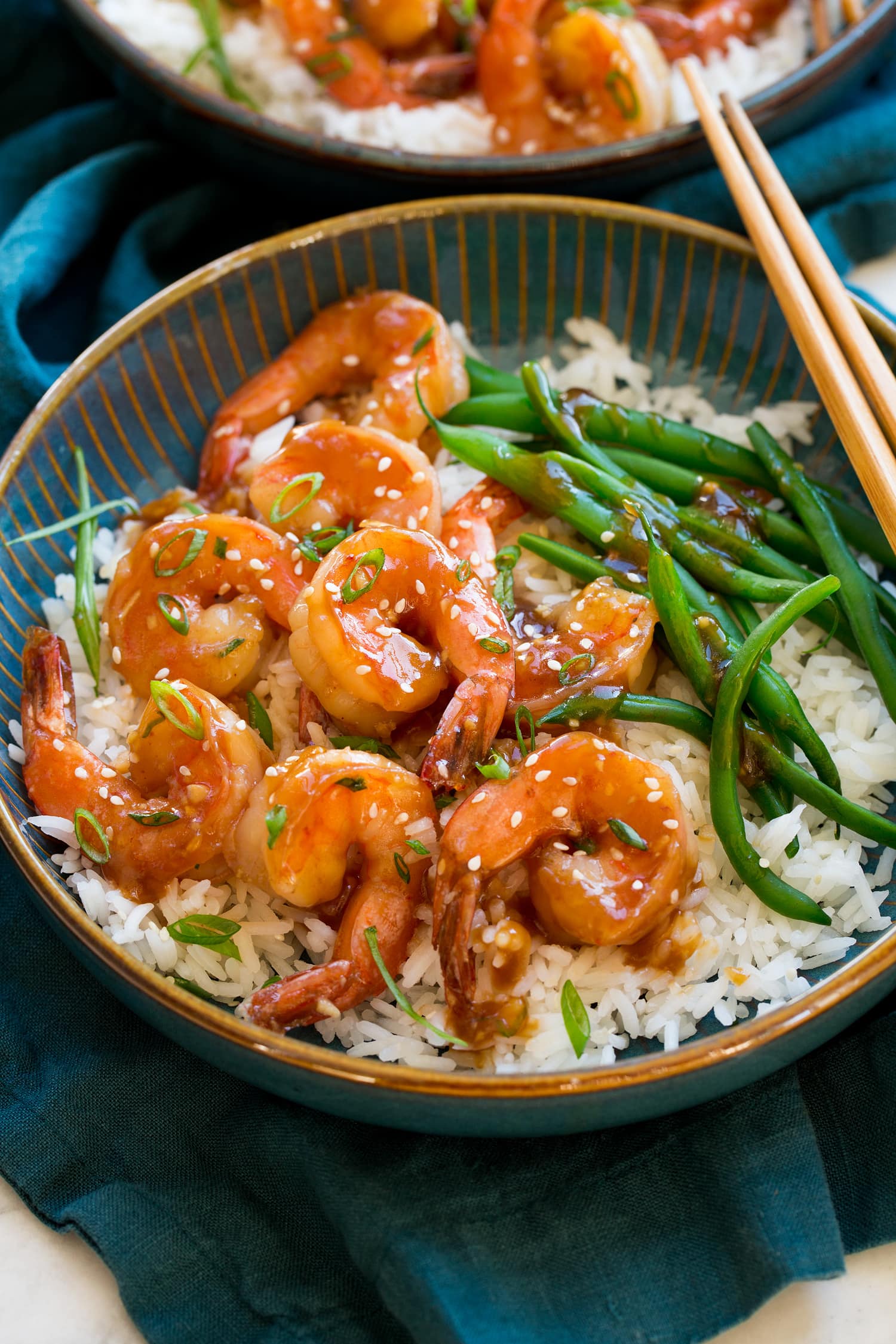 Teriyaki shrimp served with a side of steamed rice and green beans.