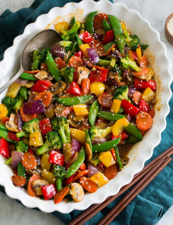 Rainbow stir fried vegetables with sauce in a serving dish.