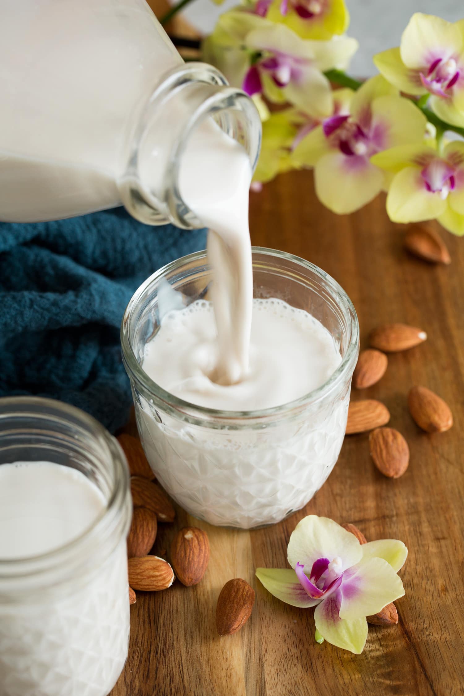 Almond milk being poured into a cup.