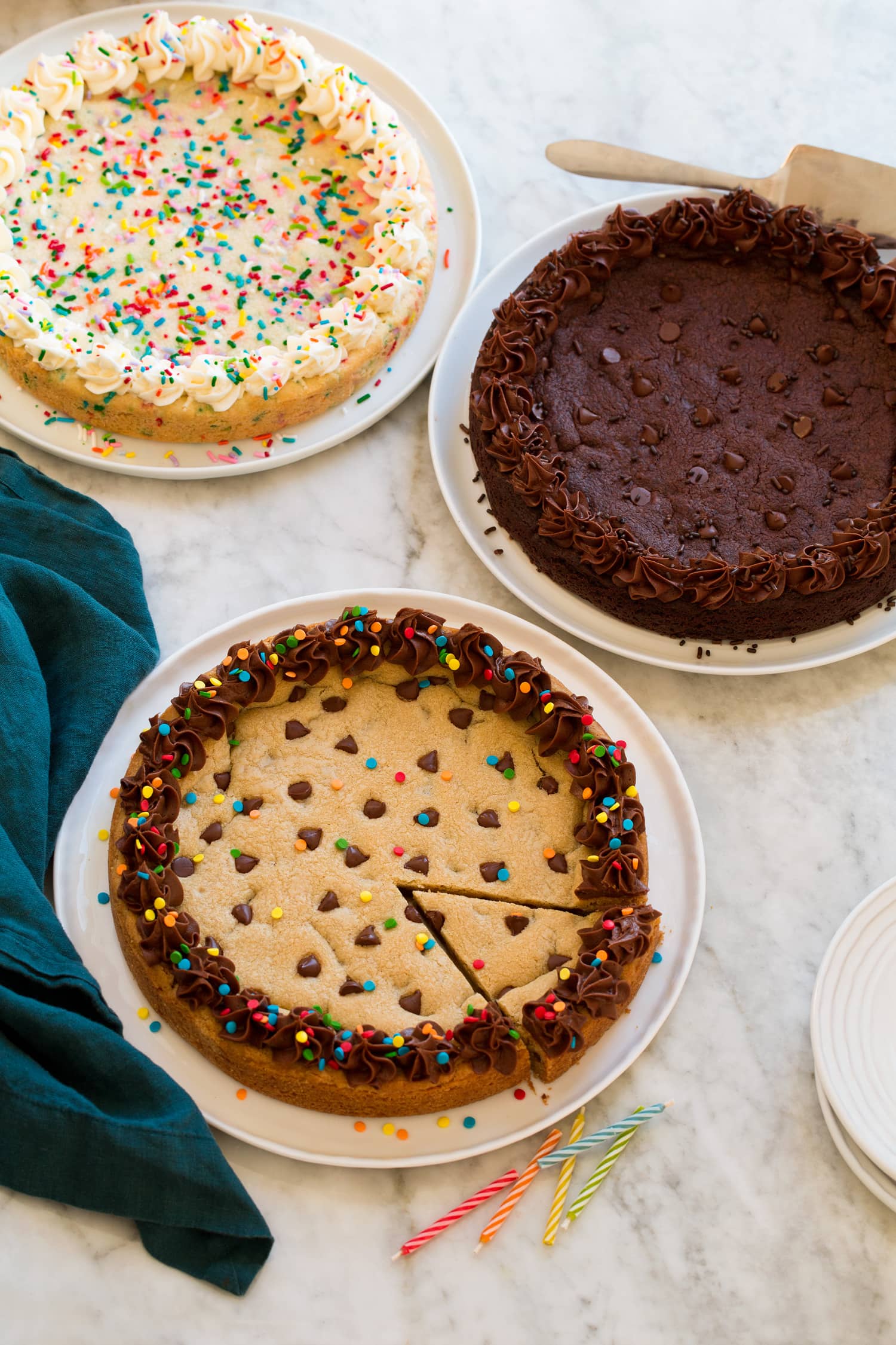 Three homemade cookie cakes. Includes chocolate chip cookie flavor, double chocolate, and funfetti.