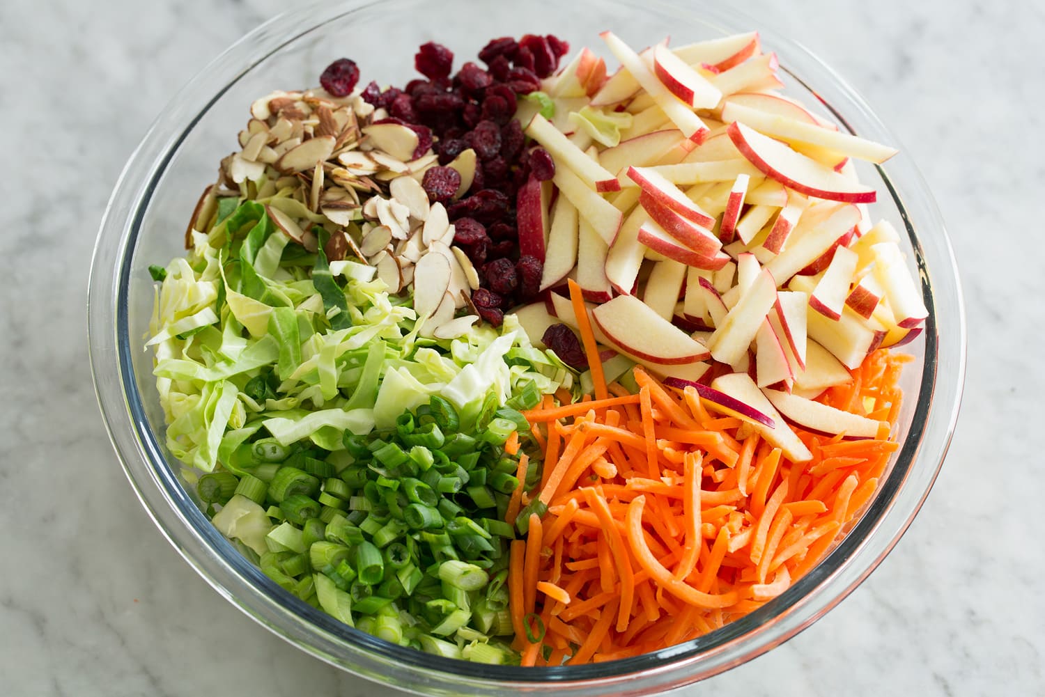 Apple slaw salad ingredients in bowl before mixing.